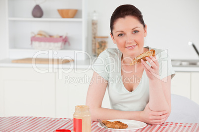 Beautiful woman posing while eating a slice of bread
