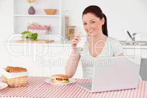 Good looking woman posing with a glass of milk while relaxing wi
