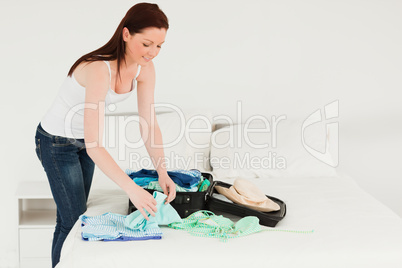 Beautiful woman packing her suitcase