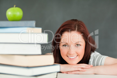 Young student with an apple and books in the foreground