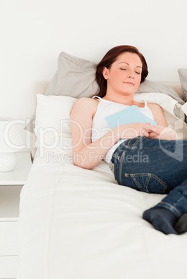 Pretty female having a rest while holding a book