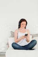Good looking female relaxing with her mp3