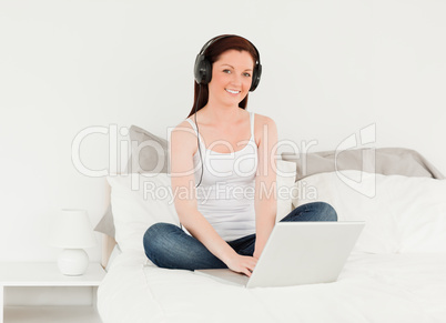 Pretty woman relaxing with her laptop