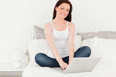 Attractive woman relaxing with her laptop