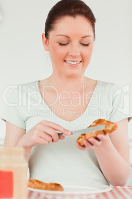 Cute woman preparing a slice of bread and marmalade