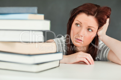 Young student looking at the amount of books she has to read