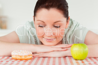 Attractive woman posing with a donut and a green apple