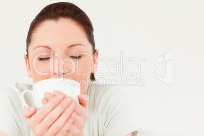 Beautiful female drinking a bowl of coffee