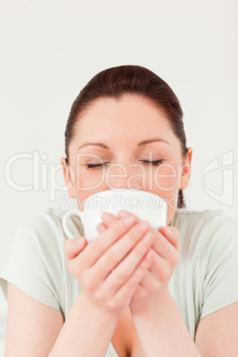 Attractive female drinking a bowl of coffee