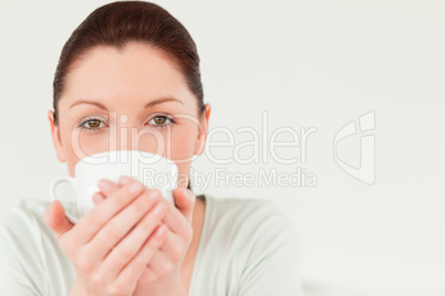 Good looking female posing while holding a bowl