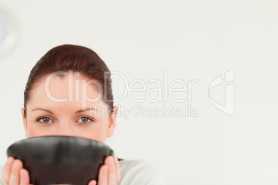 Charming female posing while holding a bowl