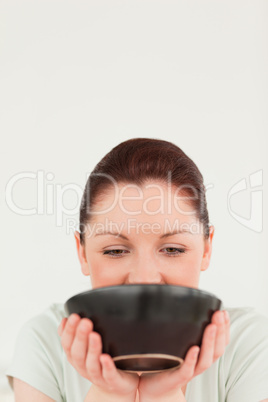 Pretty woman posing while holding a bowl