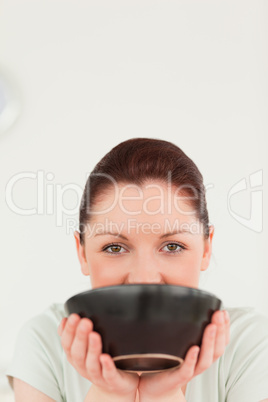 Good looking woman posing while holding a bowl