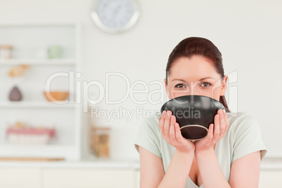 Charming woman posing while holding a bowl