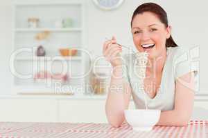 Lovely woman posing while eating pasta