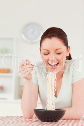 Beautiful woman posing while eating pasta