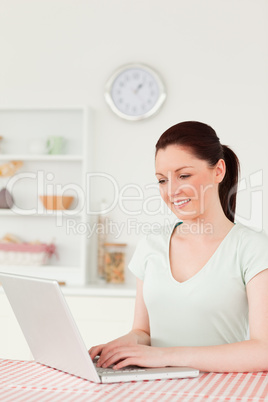 Attractive woman relaxing on her laptop