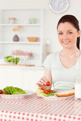 Smiling woman ready to eat a sandwich for lunch