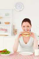 Beautiful woman eating a sandwich for lunch