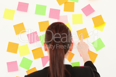 Red-haired woman taking a repositional notes