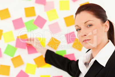 Responsible woman putting repositionable notes