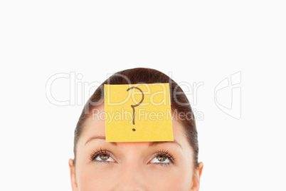 Young woman with a question tag on her forehead