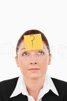 Cute businesswoman with a question tag on her forehead