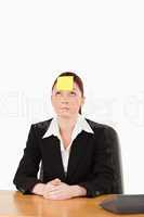 Businesswoman looking at the sign on her forehead