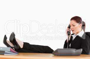 Unhappy business woman on the phone in her office