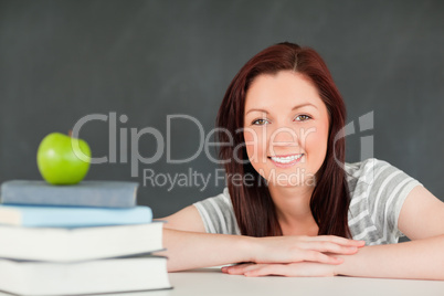 Close up of a student with books and an apple