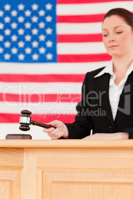 Portrait of a focused judge knocking a gavel