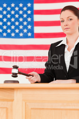 Portrait of a serious judge knocking a gavel