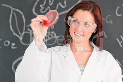 Red-haired scientist holding a petri dish