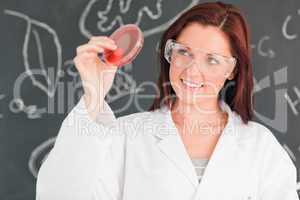 Red-haired scientist holding a petri dish