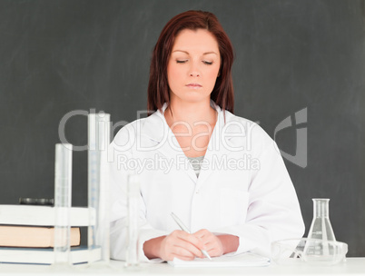 Serious scientist taking notes