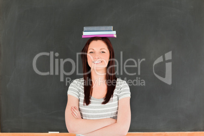 Smilling cute woman wearing books on her head