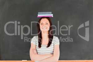 Smilling cute woman wearing books on her head