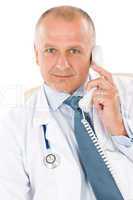 Mature doctor male on phone professional look