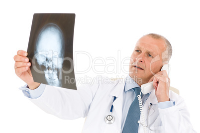 Mature senior doctor male look at x-ray