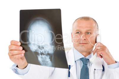 Mature senior doctor male look at x-ray