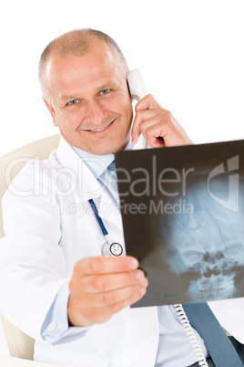 Mature senior doctor male look at x-ray