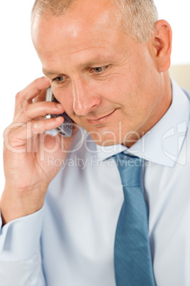 Smiling businessman on phone close-up portrait