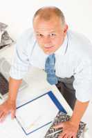 Senior man standing above office table