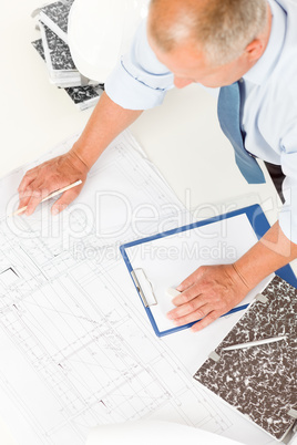 Senior man work on blueprints construction plans