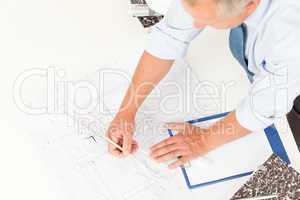 Senior man work on blueprints construction plans