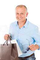Mature smilling man hold shopping bags