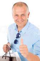 Senior happy man shopping thumb up