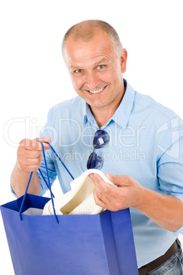 Mature smilling man hold shopping bags