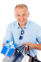 Mature smilling man hold shopping bags