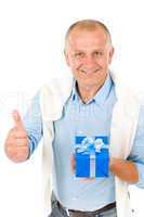 Senior happy man hold present thumb up